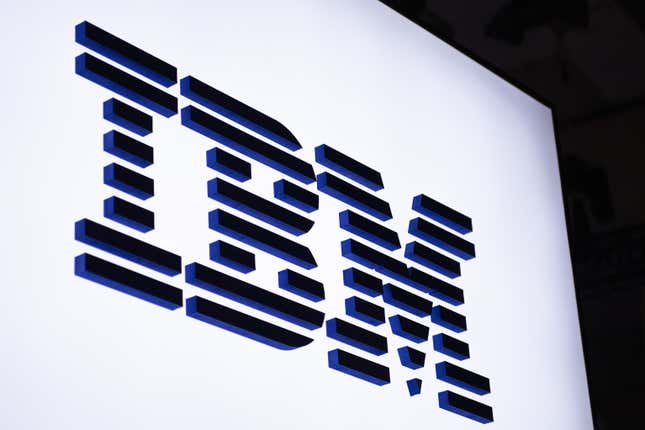 logo sits illuminated outside the IBM booth