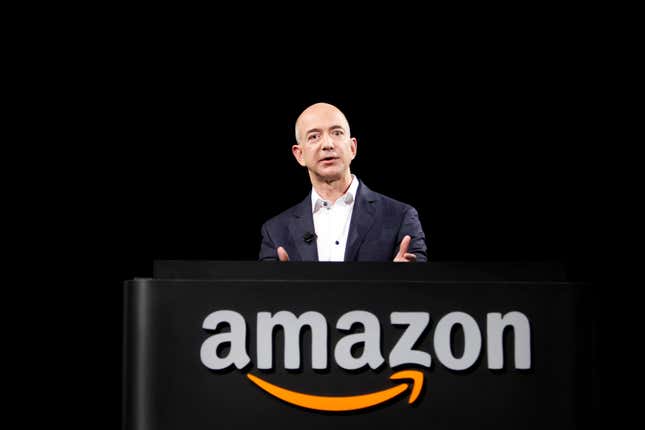 Jeff Bezos speaking at a podium that has the Amazon logo on the front
